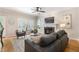 Cozy living room featuring a fireplace, comfortable seating, and ample natural light at 3310 Chartwell Blvd, Suwanee, GA 30024