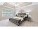 Relaxing bedroom offers tray ceiling, neutral paint, and large windows with natural light at 3310 Chartwell Blvd, Suwanee, GA 30024