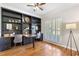 Bright office space featuring custom built-in shelving, hardwood floors, and shuttered windows at 3310 Chartwell Blvd, Suwanee, GA 30024