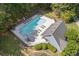 Aerial view of a community swimming pool with lounge chairs and manicured landscaping at 3310 Chartwell Blvd, Suwanee, GA 30024