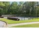 Community tennis court surrounded by lush greenery and well-maintained landscaping at 3310 Chartwell Blvd, Suwanee, GA 30024