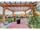 Backyard patio featuring a pergola, brick pavers, and green foliage, perfect for outdoor living at 3431-0 Tioga Lake Cv, Lawrenceville, GA 30044