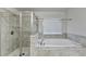 Bathroom featuring a separate shower and a soaking tub with tile surround and natural light at 3431-0 Tioga Lake Cv, Lawrenceville, GA 30044