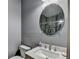 Bathroom featuring a white vanity, oval mirror, and shower at 3431-0 Tioga Lake Cv, Lawrenceville, GA 30044