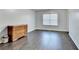 Spacious bedroom with hardwood floors, large window, and a dresser at 3431-0 Tioga Lake Cv, Lawrenceville, GA 30044