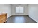 Spacious bedroom with hardwood floors, large window, and a dresser at 3431-0 Tioga Lake Cv, Lawrenceville, GA 30044
