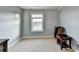 Cozy bedroom with light-blue walls, carpeted floor, ample natural light, and sufficient space for a desk at 3431-0 Tioga Lake Cv, Lawrenceville, GA 30044
