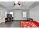 Primary bedroom with vaulted ceilings, dual windows, wood-look floors, and a wall-mounted television at 3431-0 Tioga Lake Cv, Lawrenceville, GA 30044