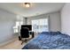 Bedroom with neutral carpet and walls, window, desk, tv and a bed at 3431-0 Tioga Lake Cv, Lawrenceville, GA 30044