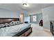 Comfortable bedroom with plush carpeting, a large window, and light-blue painted walls at 3431-0 Tioga Lake Cv, Lawrenceville, GA 30044