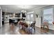 Dining area adjacent to kitchen, featuring hardwood floors and natural light at 3431-0 Tioga Lake Cv, Lawrenceville, GA 30044
