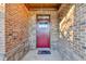 Inviting front entrance with a red door framed by brick and stone accents at 3431-0 Tioga Lake Cv, Lawrenceville, GA 30044