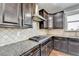 Kitchen features stainless cooktop and granite countertops with ample counter space at 3431-0 Tioga Lake Cv, Lawrenceville, GA 30044