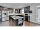 Spacious kitchen features stainless steel appliances, granite countertops, tile backsplash, and dark wood cabinets at 3431-0 Tioga Lake Cv, Lawrenceville, GA 30044