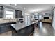 Kitchen flows into living and dining area, featuring an island, granite counters, and stainless appliances at 3431-0 Tioga Lake Cv, Lawrenceville, GA 30044