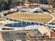 Bird's eye view showcases walkable park and recreation areas, and a mix of commercial buildings in the area at 3930 Charleston Market St # 221, Suwanee, GA 30024