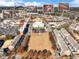 Aerial view showcasing the community's central green space, shops, restaurants, and surrounding residential area at 3930 Charleston Market St # 221, Suwanee, GA 30024