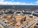 Wide aerial view featuring community layout, green space, commercial area, and surrounding residential neighborhoods at 3930 Charleston Market St # 221, Suwanee, GA 30024