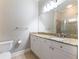 Updated bathroom features granite countertop, white cabinets, tile flooring, and glass shower at 3930 Charleston Market St # 221, Suwanee, GA 30024