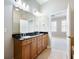 Bright bathroom with double sink vanity, granite countertop, and a view into the bedroom at 3930 Charleston Market St # 221, Suwanee, GA 30024