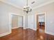 Spacious dining room with hardwood floors, neutral paint and chandelier at 3930 Charleston Market St # 221, Suwanee, GA 30024