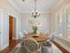 Dining room features hardwood floors, neutral paint and a shuttered window at 3930 Charleston Market St # 221, Suwanee, GA 30024