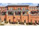 Multi-level red brick building with multiple balconies and private entrances at 3930 Charleston Market St # 221, Suwanee, GA 30024