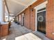 Inviting brick townhome entrance featuring a covered porch with classic columns and stylish front door wreath at 3930 Charleston Market St # 221, Suwanee, GA 30024