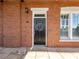 Charming brick front exterior with black front door, decorative wreath and classic architectural details at 3930 Charleston Market St # 221, Suwanee, GA 30024