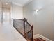 Upstairs hallway features carpet floors, decorative lighting, and wood and iron railings at 3930 Charleston Market St # 221, Suwanee, GA 30024