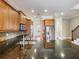 Modern kitchen with stainless steel appliances, granite countertops and light wood cabinetry at 3930 Charleston Market St # 221, Suwanee, GA 30024
