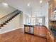 Bright kitchen with stainless steel appliances, granite counters, hardwood floors and nearby staircase at 3930 Charleston Market St # 221, Suwanee, GA 30024