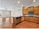 Well-lit kitchen flows into living area with stainless steel appliances, granite countertops, and hardwood floors at 3930 Charleston Market St # 221, Suwanee, GA 30024