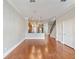 Open living space with hardwood floors connects to kitchen with nearby staircase and ample natural light at 3930 Charleston Market St # 221, Suwanee, GA 30024
