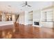 Spacious living room with hardwood floors features built-in bookcases and a cozy fireplace at 3930 Charleston Market St # 221, Suwanee, GA 30024