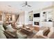 Cozy living room with fireplace, complemented by comfortable seating and a view of the open kitchen at 3930 Charleston Market St # 221, Suwanee, GA 30024