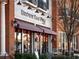 Charming Brown Bag Deli exterior with outdoor seating, vintage lighting, and patriotic decor at 3930 Charleston Market St # 221, Suwanee, GA 30024