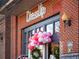 DressUp retail entrance with festive pink and white balloon decor and wreath at 3930 Charleston Market St # 221, Suwanee, GA 30024