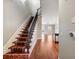 Open staircase with decorative carpet runner and hardwood floors at 3930 Charleston Market St # 221, Suwanee, GA 30024