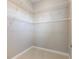 Spacious walk-in closet featuring ample shelving for optimized storage in a neutral color scheme at 3930 Charleston Market St # 221, Suwanee, GA 30024