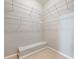 Organized walk-in closet with shelving and a built-in bench at 3930 Charleston Market St # 221, Suwanee, GA 30024