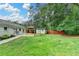 Spacious backyard showcasing the covered patio, shed, and lush green lawn at 425 Charlyne Way, Dacula, GA 30019
