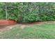 Spacious backyard with green grass and a brown wooden fence at 425 Charlyne Way, Dacula, GA 30019