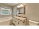 Well lit bathroom featuring soaking tub, modern vanity and granite countertops at 425 Charlyne Way, Dacula, GA 30019
