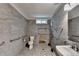 Accessible bathroom featuring grab bars, roll-in shower with bench and modern fixtures at 425 Charlyne Way, Dacula, GA 30019