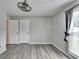 Neutral bedroom featuring natural light, modern ceiling fan, and vinyl flooring for easy maintenance at 425 Charlyne Way, Dacula, GA 30019