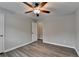 Neutral bedroom featuring gray walls, modern ceiling fan, and vinyl flooring for easy maintenance at 425 Charlyne Way, Dacula, GA 30019