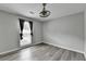 Charming bedroom featuring natural light, modern ceiling fan, and vinyl flooring for easy cleaning at 425 Charlyne Way, Dacula, GA 30019