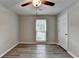 Cozy bedroom with modern flooring, neutral colors, ceiling fan, and bright window at 425 Charlyne Way, Dacula, GA 30019