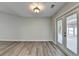 Dining room with gray wood-look flooring features access to back patio at 425 Charlyne Way, Dacula, GA 30019